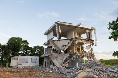 Abandoned built structure on field against sky