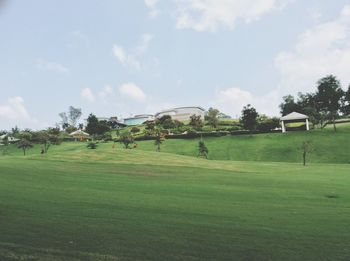 Scenic view of golf course against sky