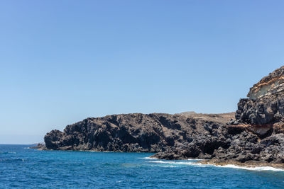 Scenic view of sea against clear blue sky