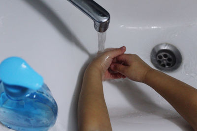 Midsection of woman in bathroom at home