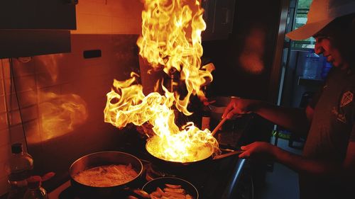 Man preparing food in kitchen at restaurant