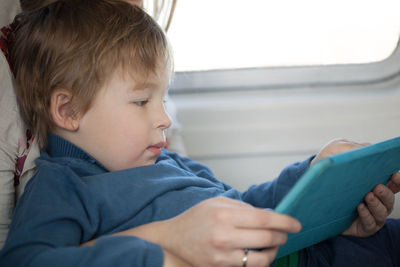 Close-up of boy using digital tablet