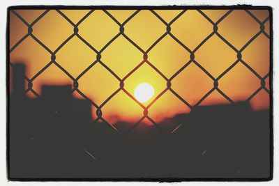 Sunset seen through chainlink fence