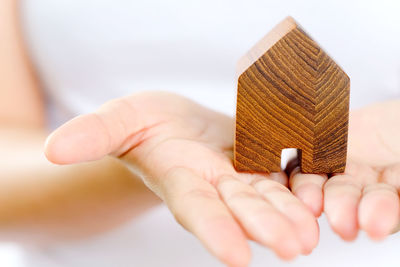 Midsection of woman holding wooden house block