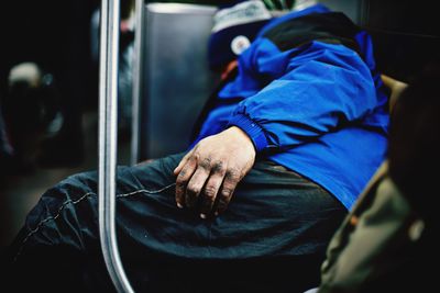 Side view of man sleeping in train