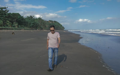 Full length of man standing on beach