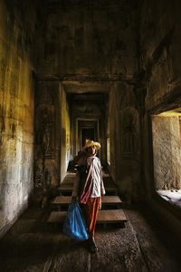 Full length of woman standing by railing