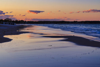 Scenic view of beach against sky during sunset