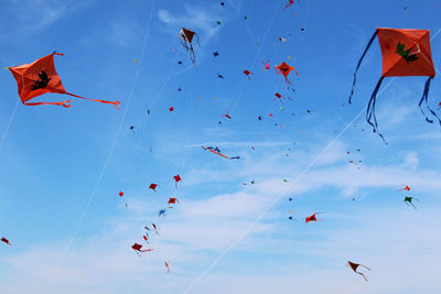 Low angle view of kites flying in sky