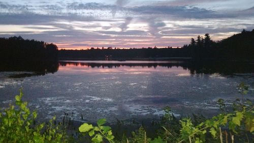 Scenic view of lake against sky during sunset