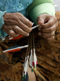 Cropped image of woman holding arrows