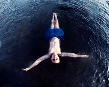 High angle view of people swimming in lake