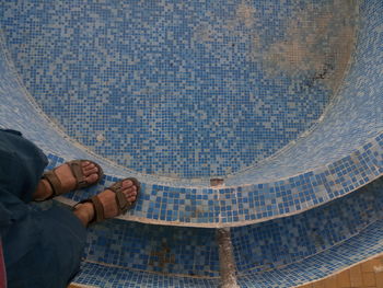 Low section of man standing on fountain