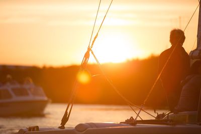 Scenic view of sailboats at sunset