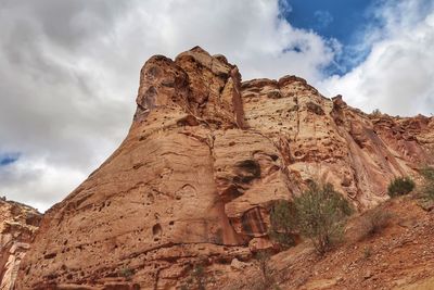 Low angle view of rock formation against sky