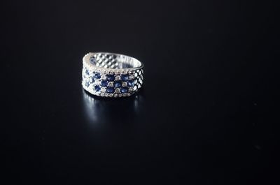 Close-up of wedding rings on table against black background