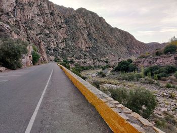 Road amidst mountains against sky