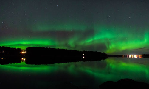 Scenic view of lake against sky at night