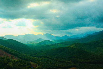 Scenic view of valley and mountains against sky