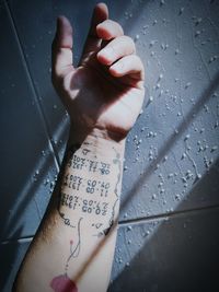 High angle view of woman hand with text