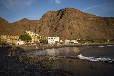 Scenic view of sea and mountains against sky