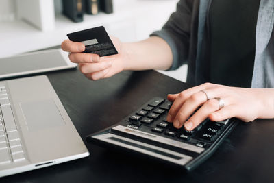 Midsection of businessman using laptop