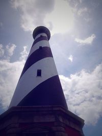 Low angle view of lighthouse against cloudy sky