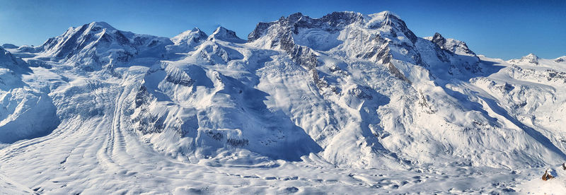 Aerial view of snowcapped mountains against sky