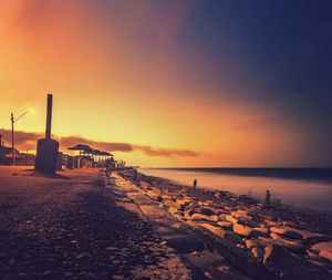 Scenic view of beach against sky during sunset