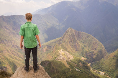 Rear view of man looking at mountains