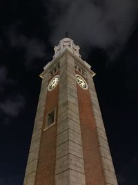 Low angle view of clock tower against sky