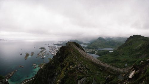 Scenic view of landscape and coastal city against sky from a mountain top