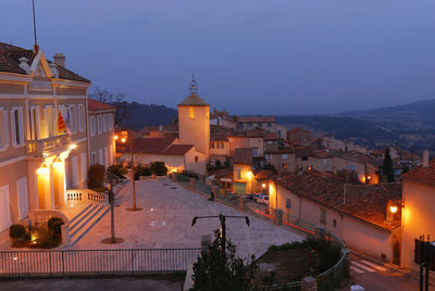 High angle view of illuminated buildings against sky at dusk