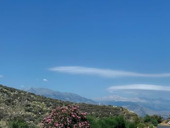 Scenic view of mountains against blue sky