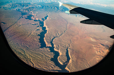 Aerial view of landscape seen through airplane window