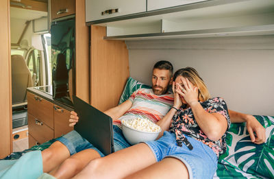 Couple watching movie in motor home