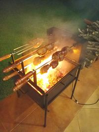 High angle view of meat on barbecue grill