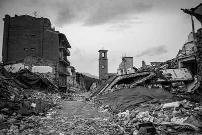 Abandoned building on field against sky