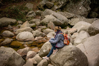 Woman sitting on rock