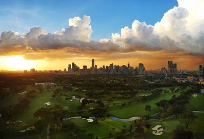 View of cityscape against cloudy sky