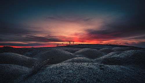 Scenic view of land against sky during sunset