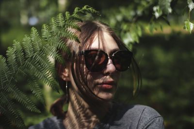 Portrait of young woman wearing sunglasses