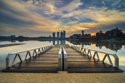 View of buildings against cloudy sky during sunset