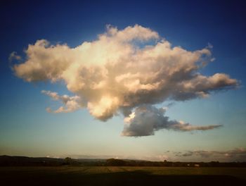 Scenic view of landscape against cloudy sky