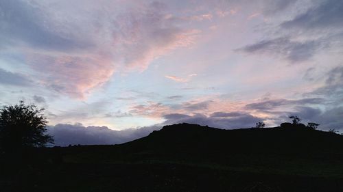 Scenic view of silhouette mountains against sky at sunset