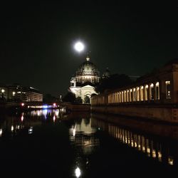 Illuminated building against sky at night