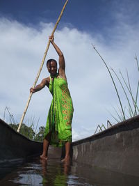 Man standing in sea against sky