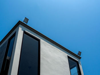 Low angle view of building against clear blue sky