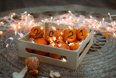 Christmas greeting card with oranges, tangerines with numbers 2021 and garland lights. new year 2021 