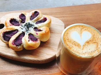 Close-up of coffee by sweet food on table